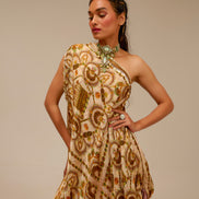 Woman wearing a patterned dress against a beige background