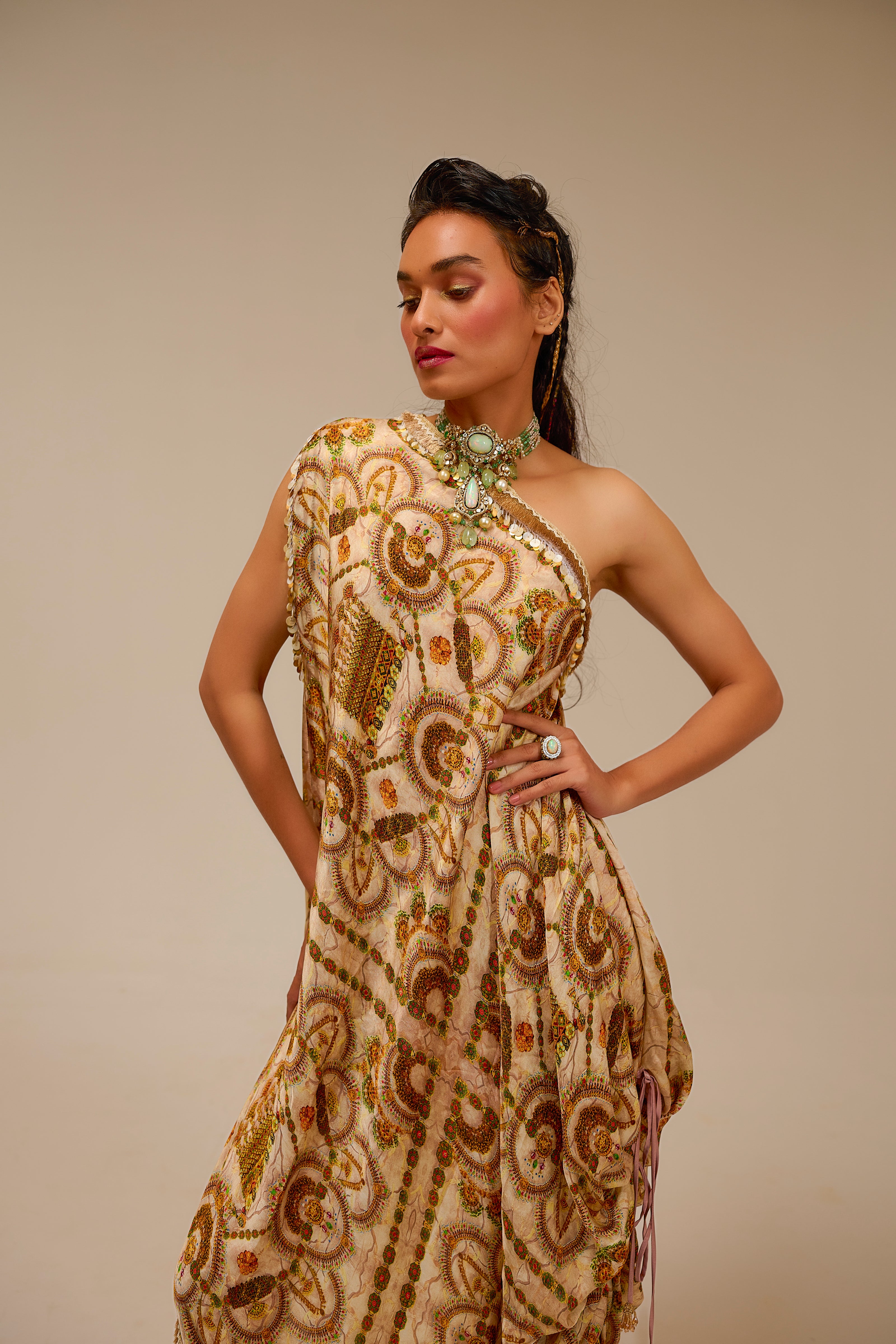 Woman wearing a patterned dress against a beige background