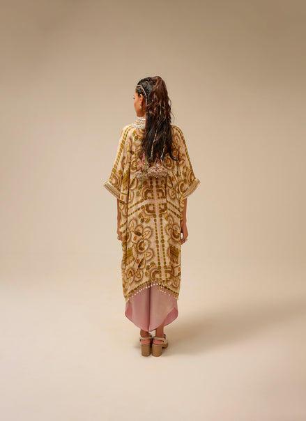 Woman wearing a patterned dress with a plain background