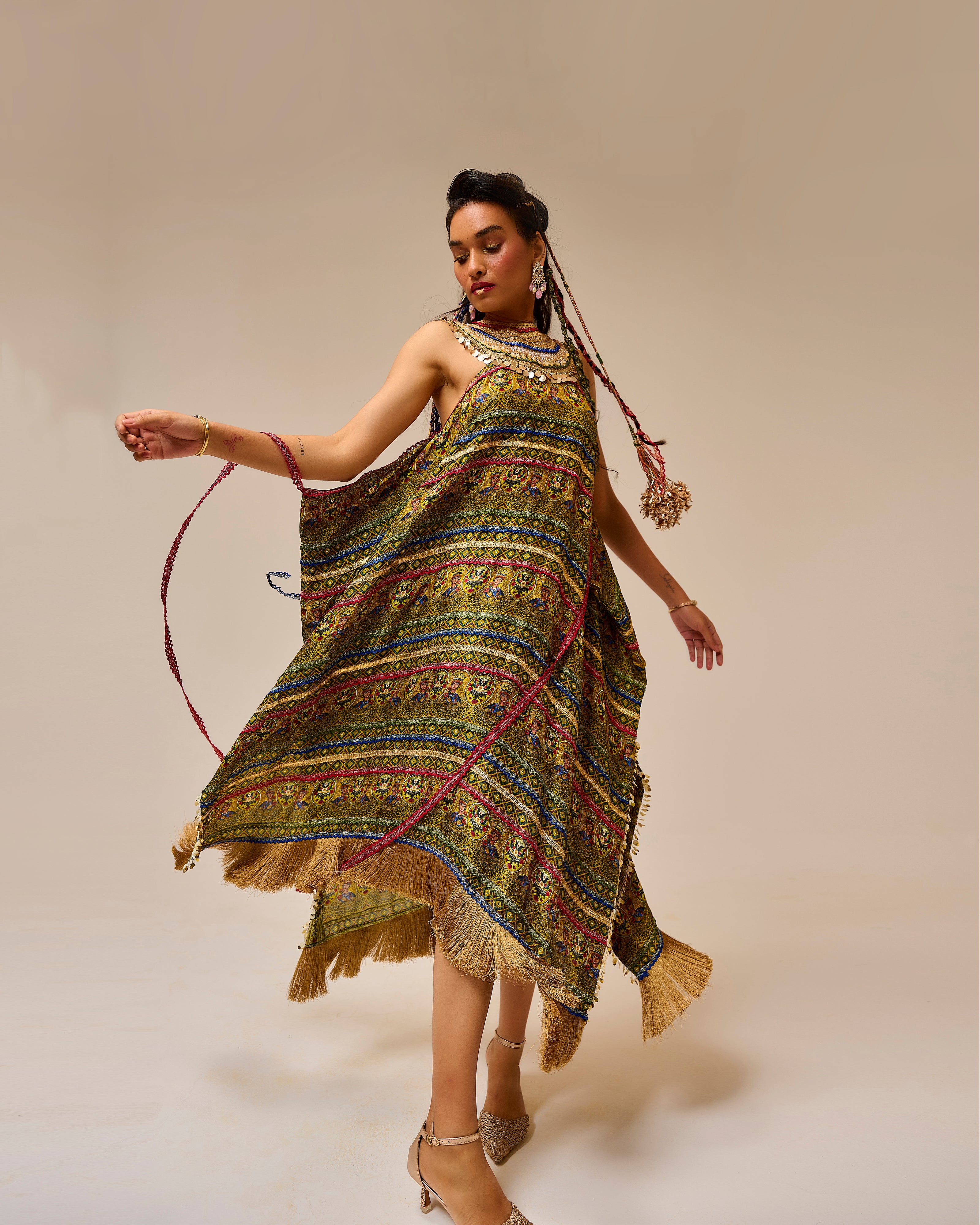 Woman wearing a colorful patterned dress with a plain background