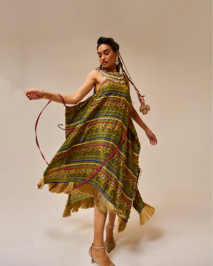 Woman wearing a colorful patterned dress with a plain background