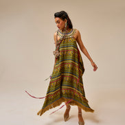 Woman wearing a colorful patterned dress on a plain background