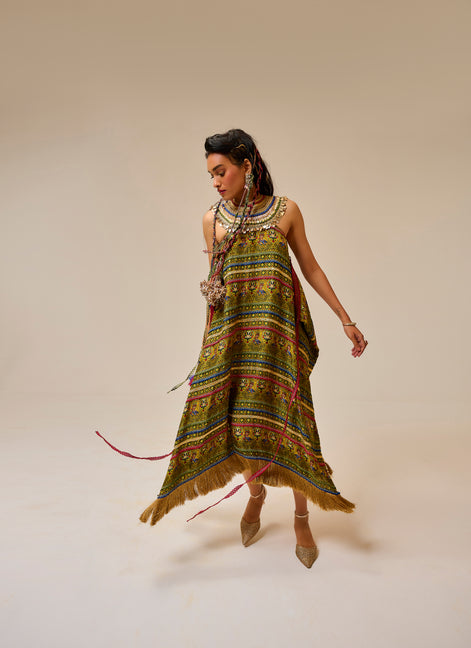 Woman wearing a colorful patterned dress on a plain background