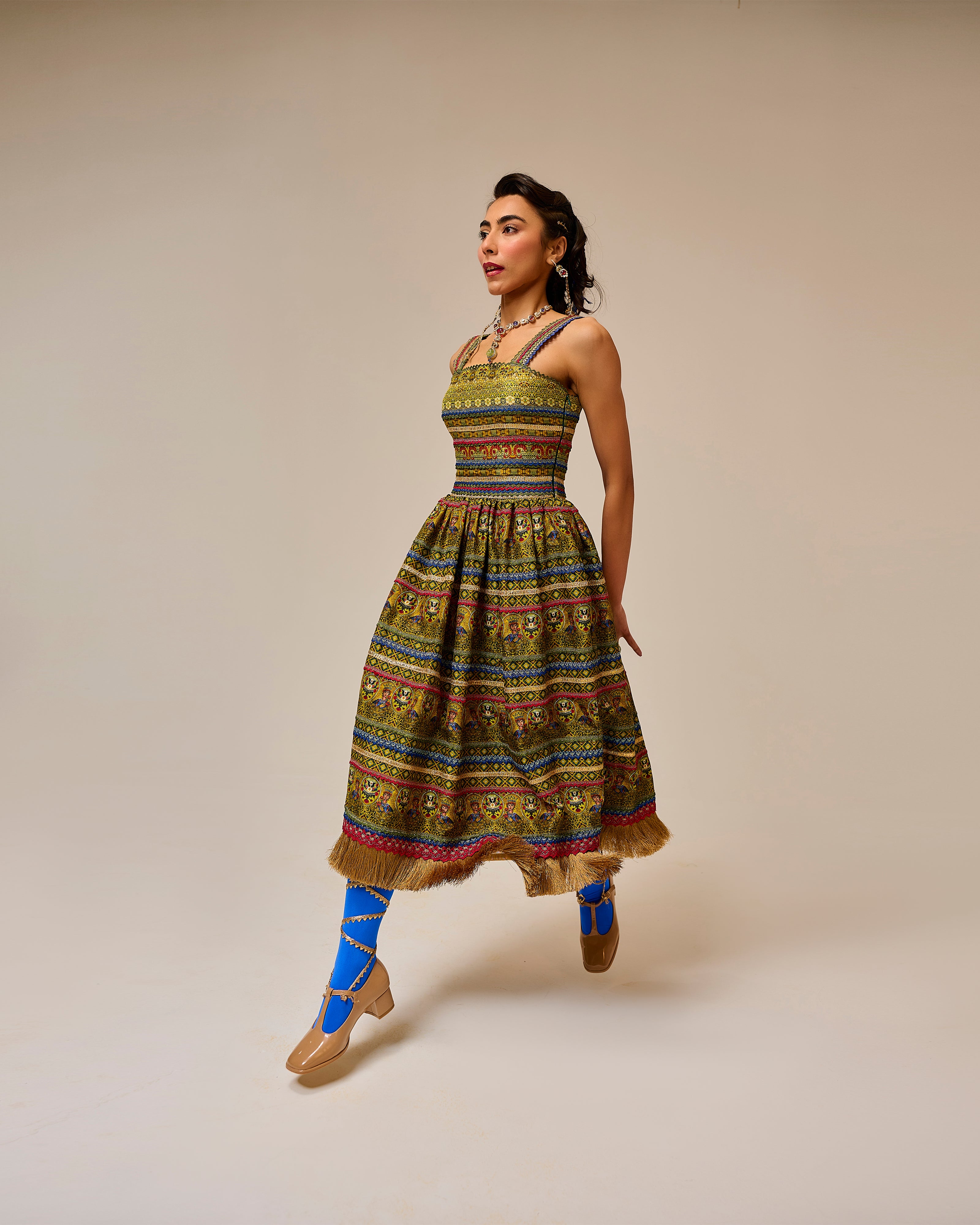 Woman wearing a colorful patterned dress on a beige background
