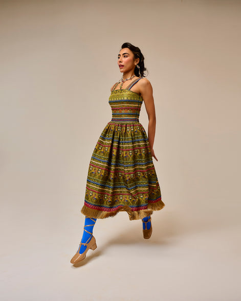 Woman wearing a colorful patterned dress on a beige background
