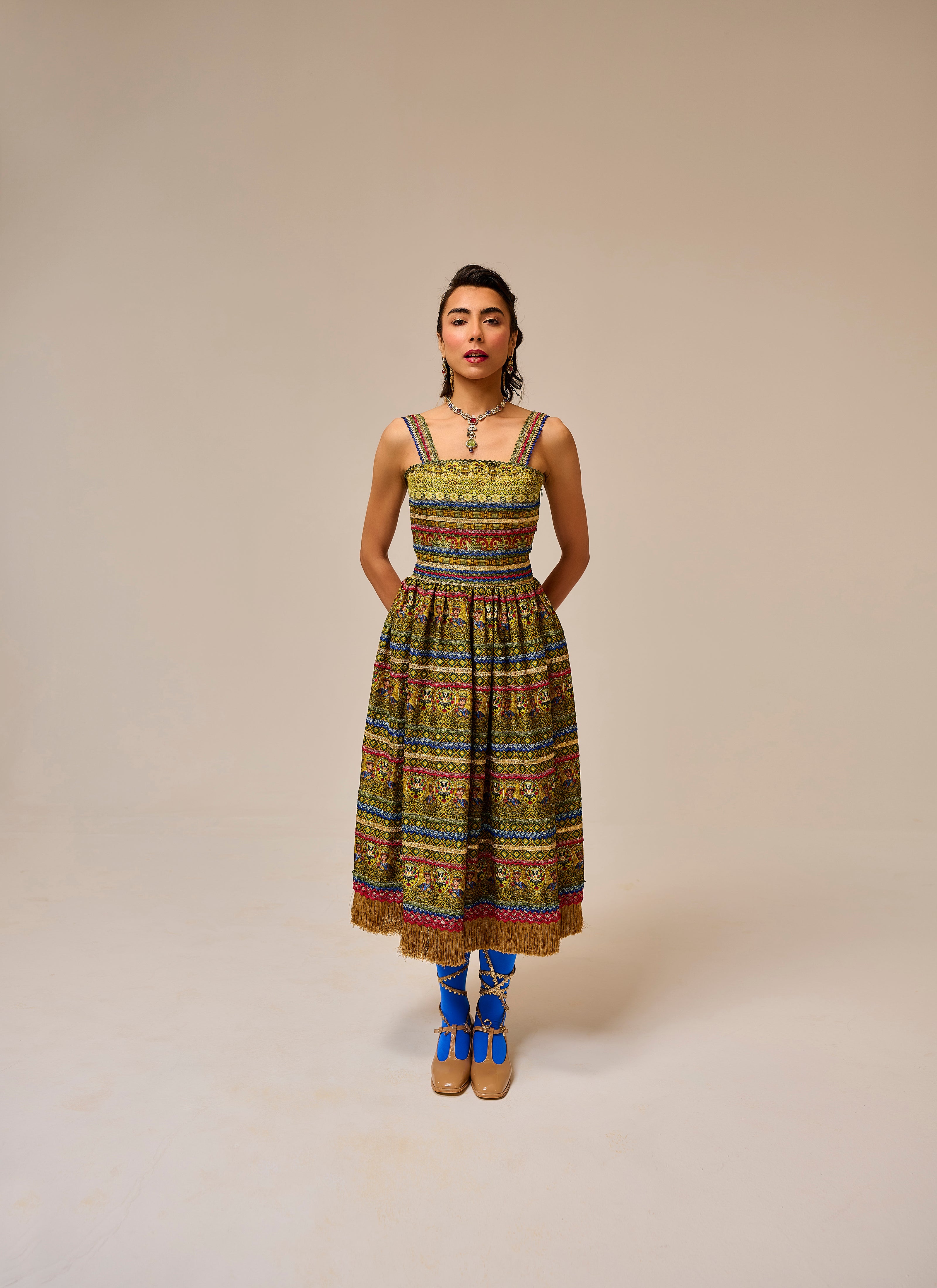 Woman wearing a colorful patterned dress on a beige background