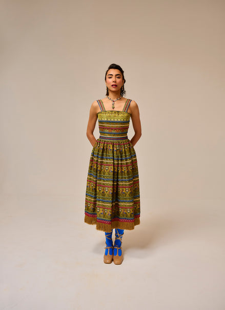 Woman wearing a colorful patterned dress on a beige background
