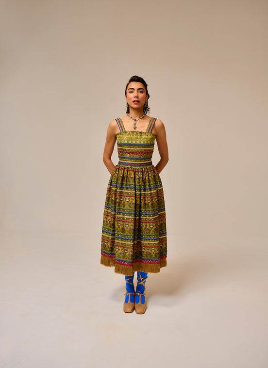 Woman wearing a colorful patterned dress on a beige background