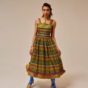 Woman wearing a colorful patterned dress with a beige background