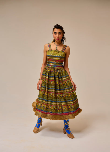Woman wearing a colorful patterned dress with a beige background