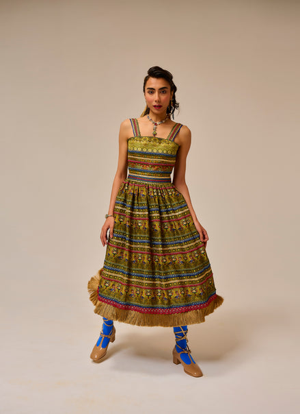 Woman wearing a colorful patterned dress with a beige background