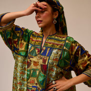 Woman wearing a colorful patterned dress against a plain background