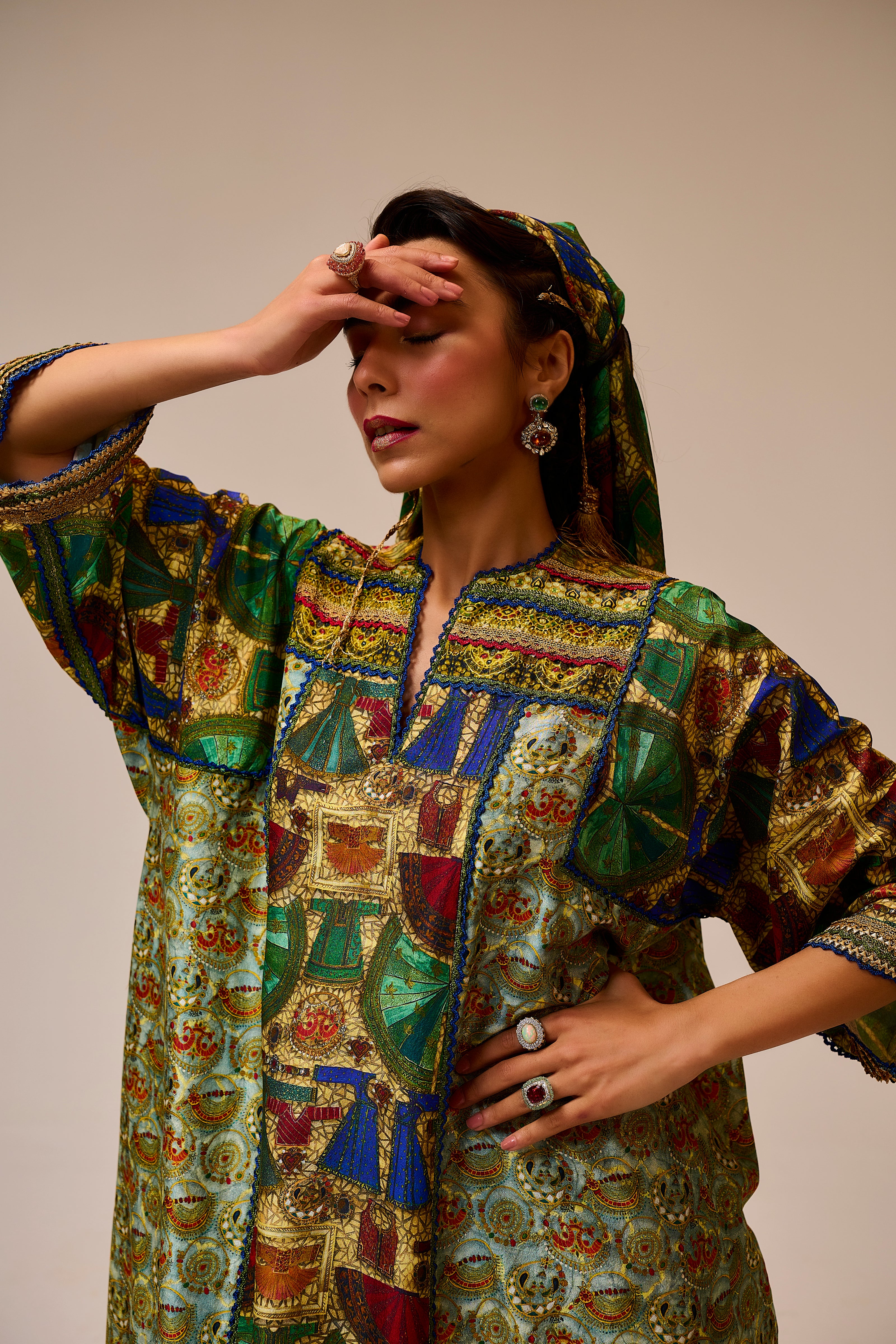 Woman wearing a colorful patterned dress against a plain background