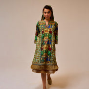 Woman wearing a colorful patterned dress on a plain background