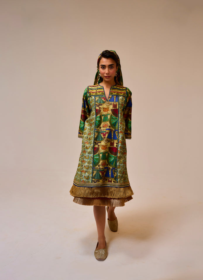 Woman wearing a colorful patterned dress on a plain background