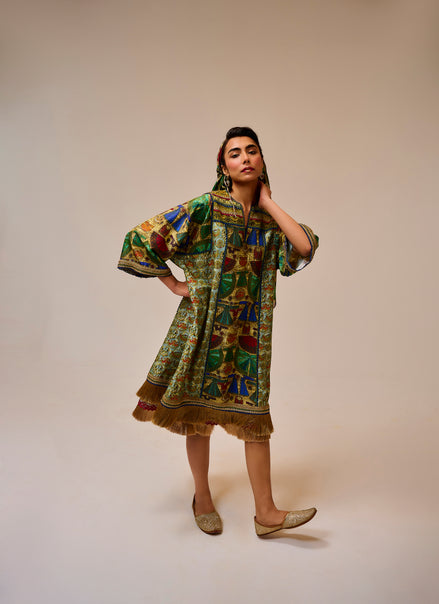 Woman wearing a colorful patterned dress on a beige background