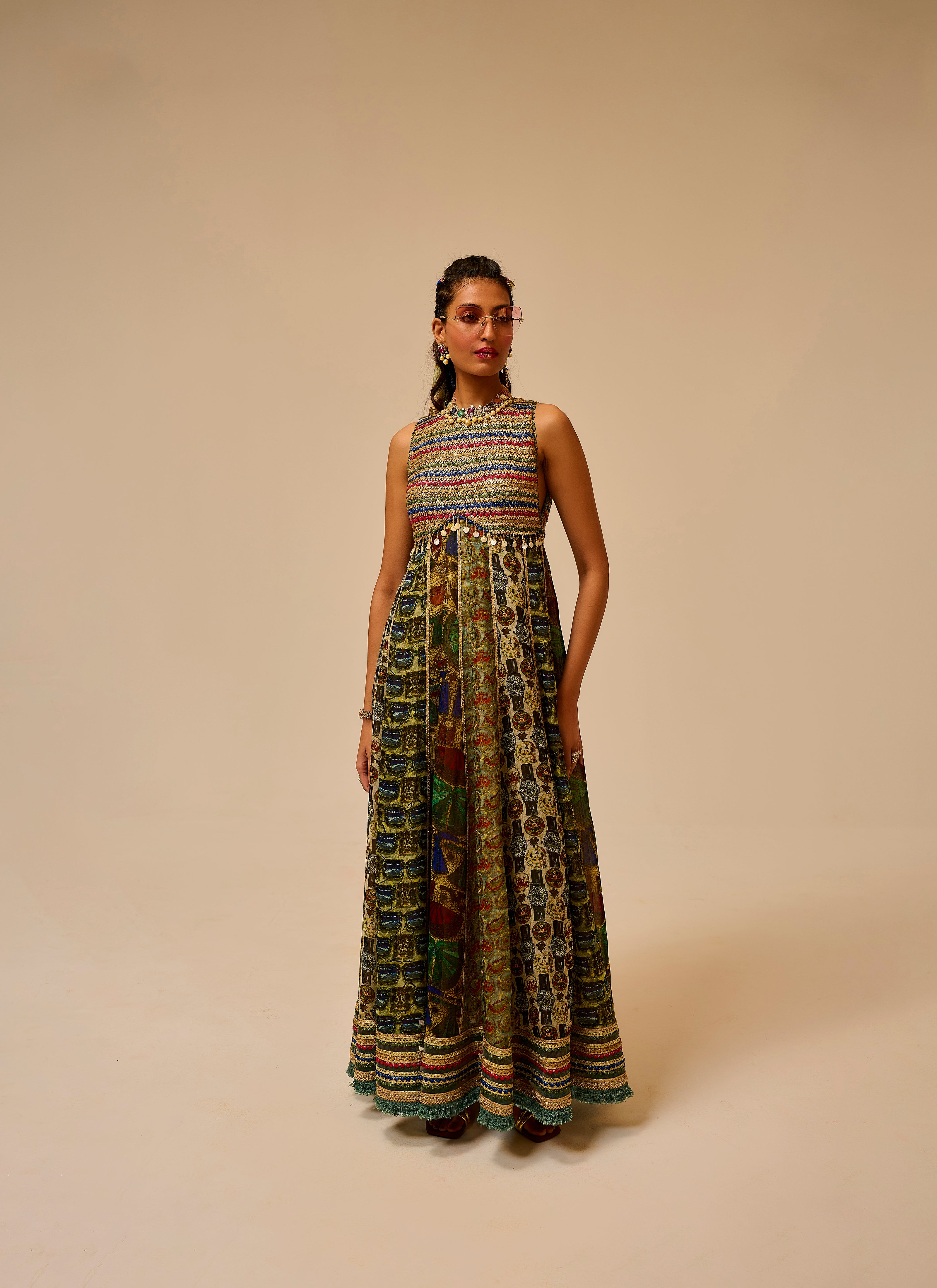 Woman wearing a colorful patterned dress on a beige background