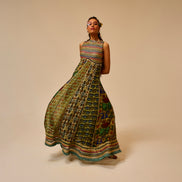 Woman wearing a colorful patterned dress on a beige background