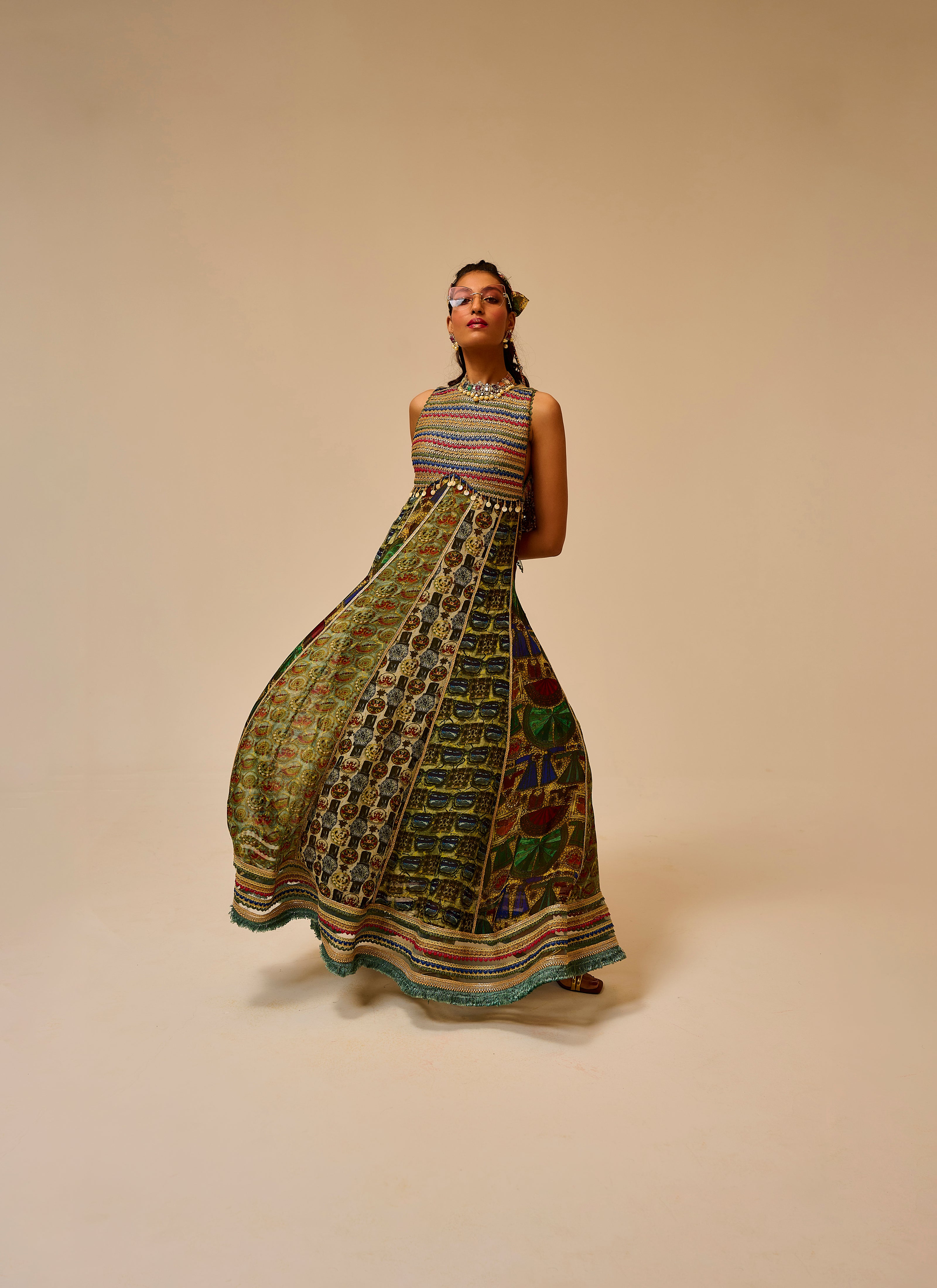 Woman wearing a colorful patterned dress on a beige background