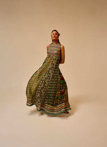Woman wearing a colorful patterned dress on a beige background