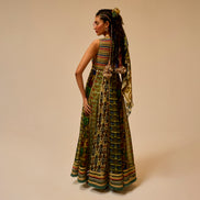 Woman wearing a long, patterned dress with a beige background