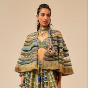 Woman wearing a patterned outfit on a beige background