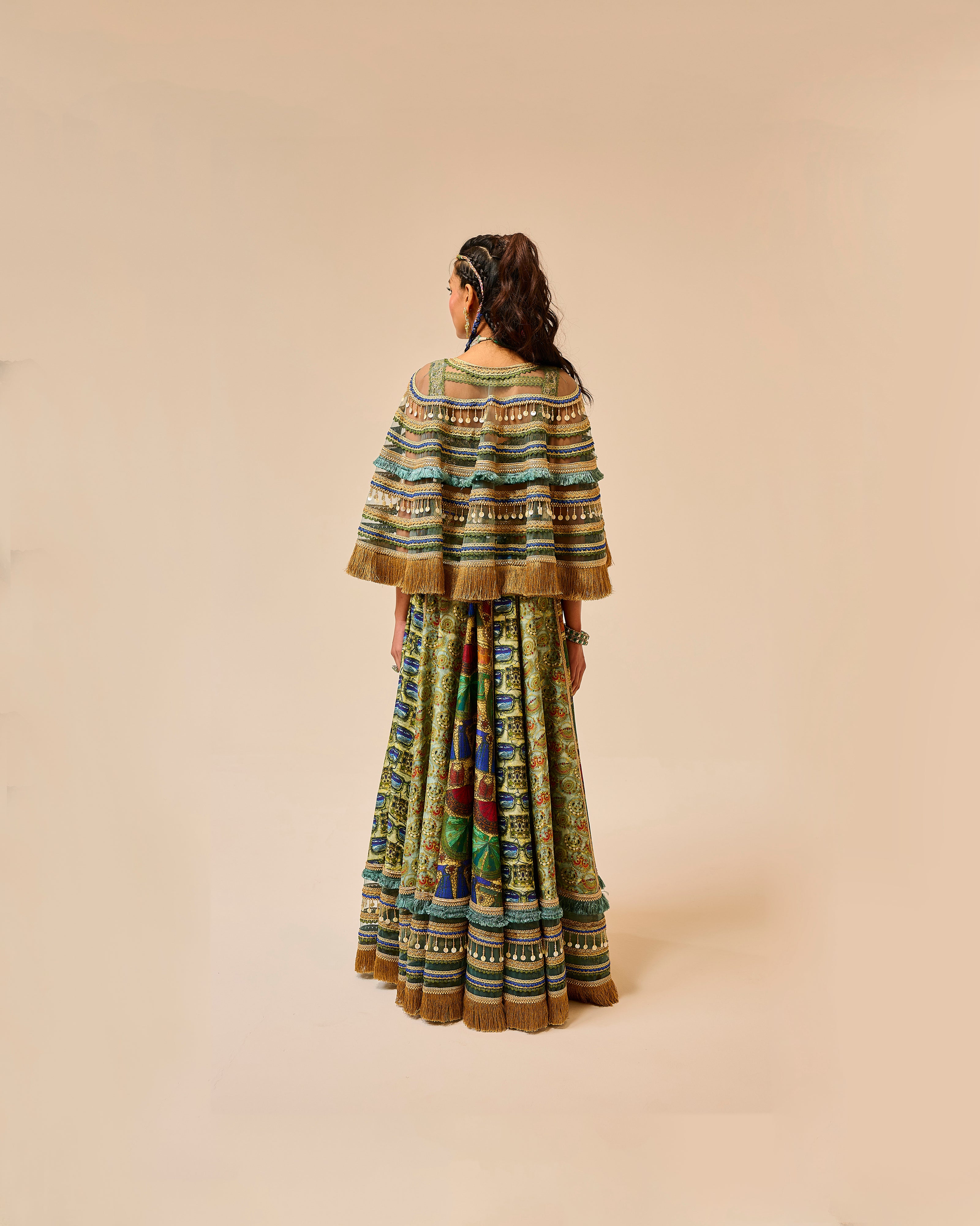 Person wearing a colorful traditional outfit on a beige background