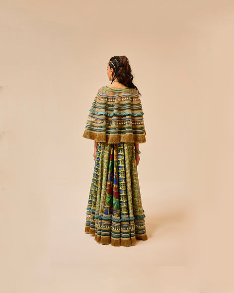 Person wearing a colorful traditional outfit on a beige background