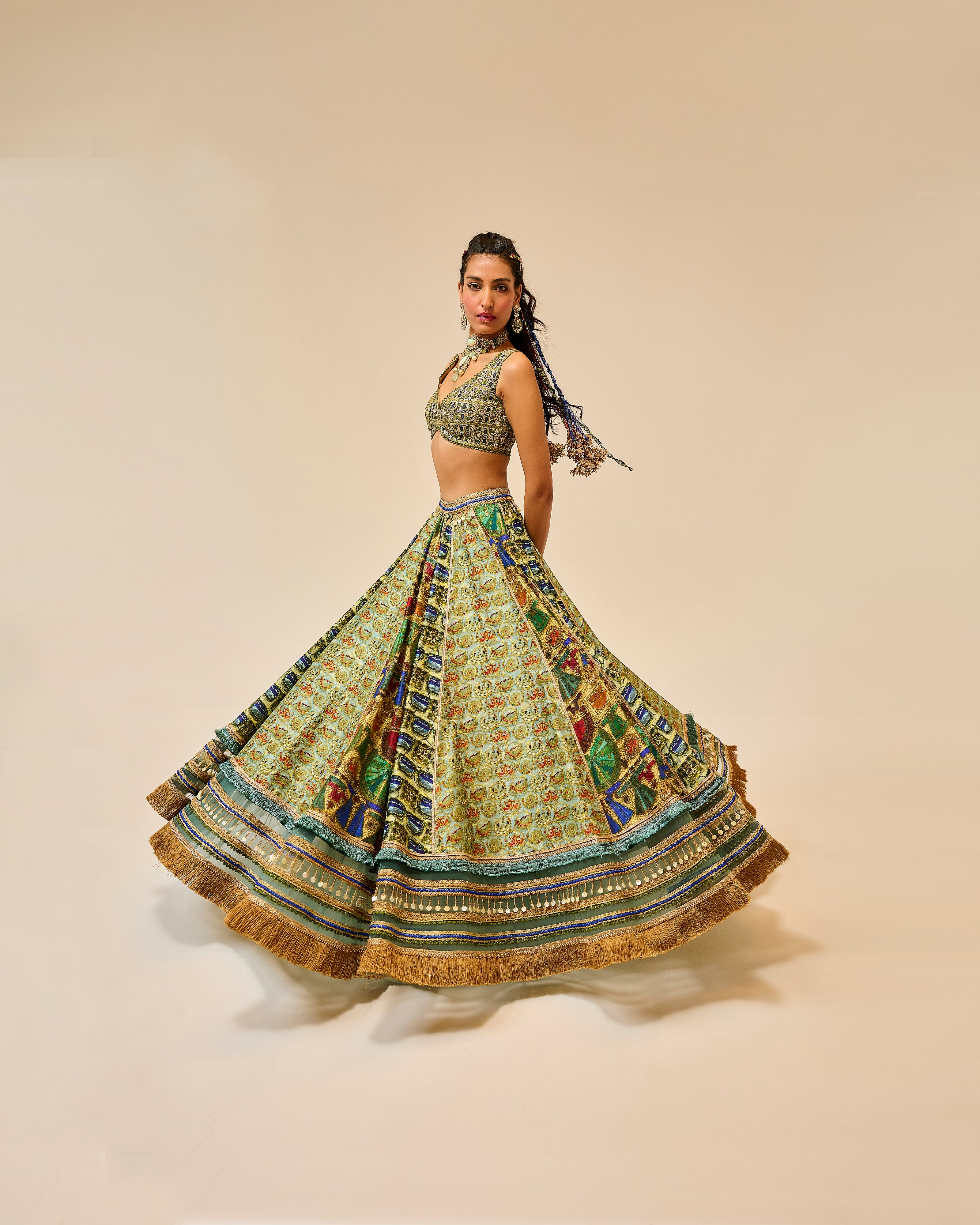 Woman wearing a traditional outfit with a patterned skirt and top on a beige background