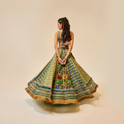 Woman wearing a colorful patterned dress on a beige background