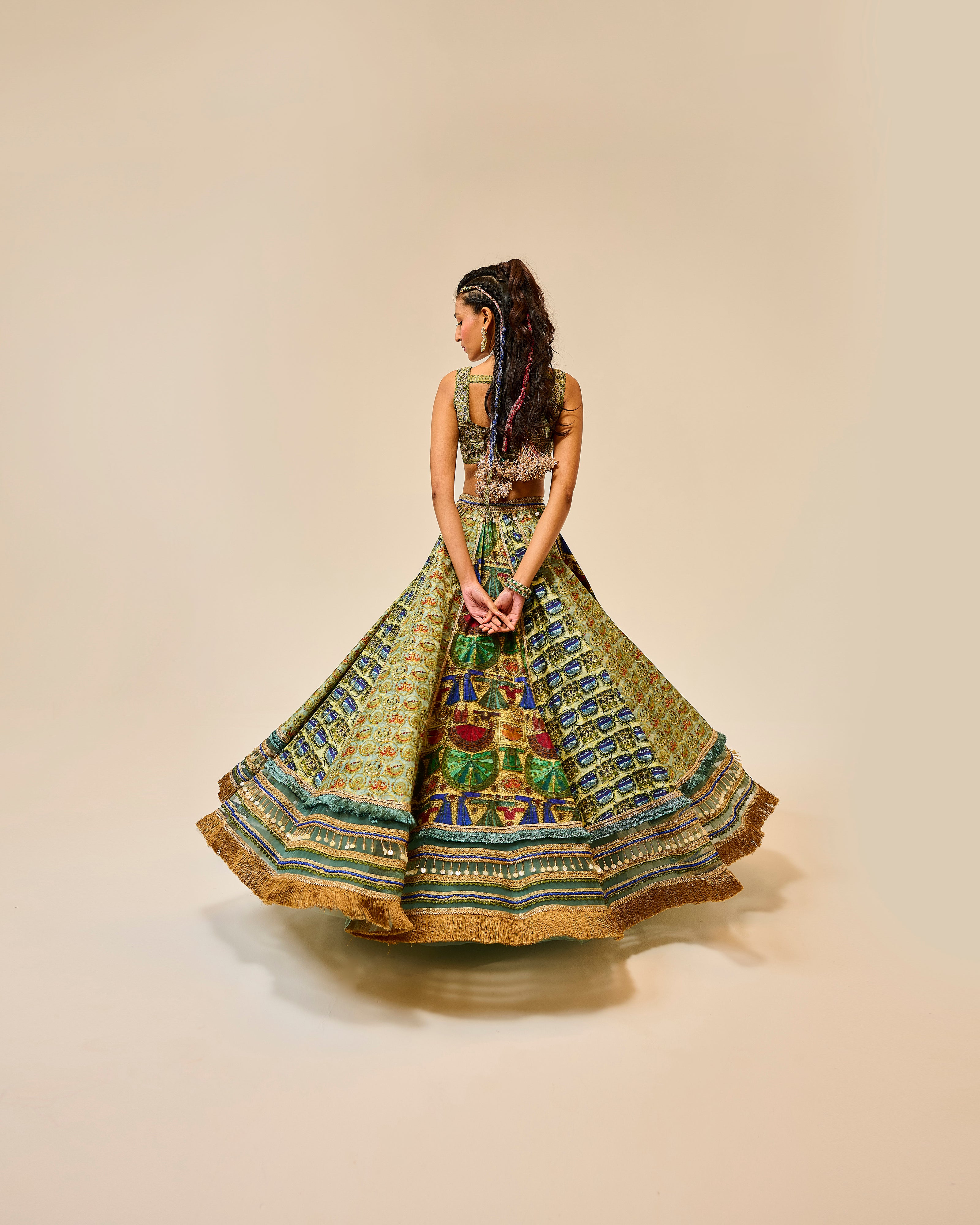 Woman wearing a colorful patterned dress on a beige background