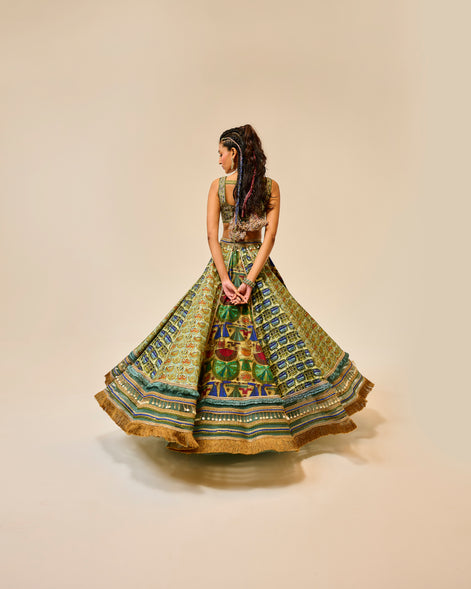 Woman wearing a colorful patterned dress on a beige background