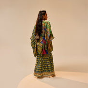 Woman wearing a colorful traditional outfit on a beige background