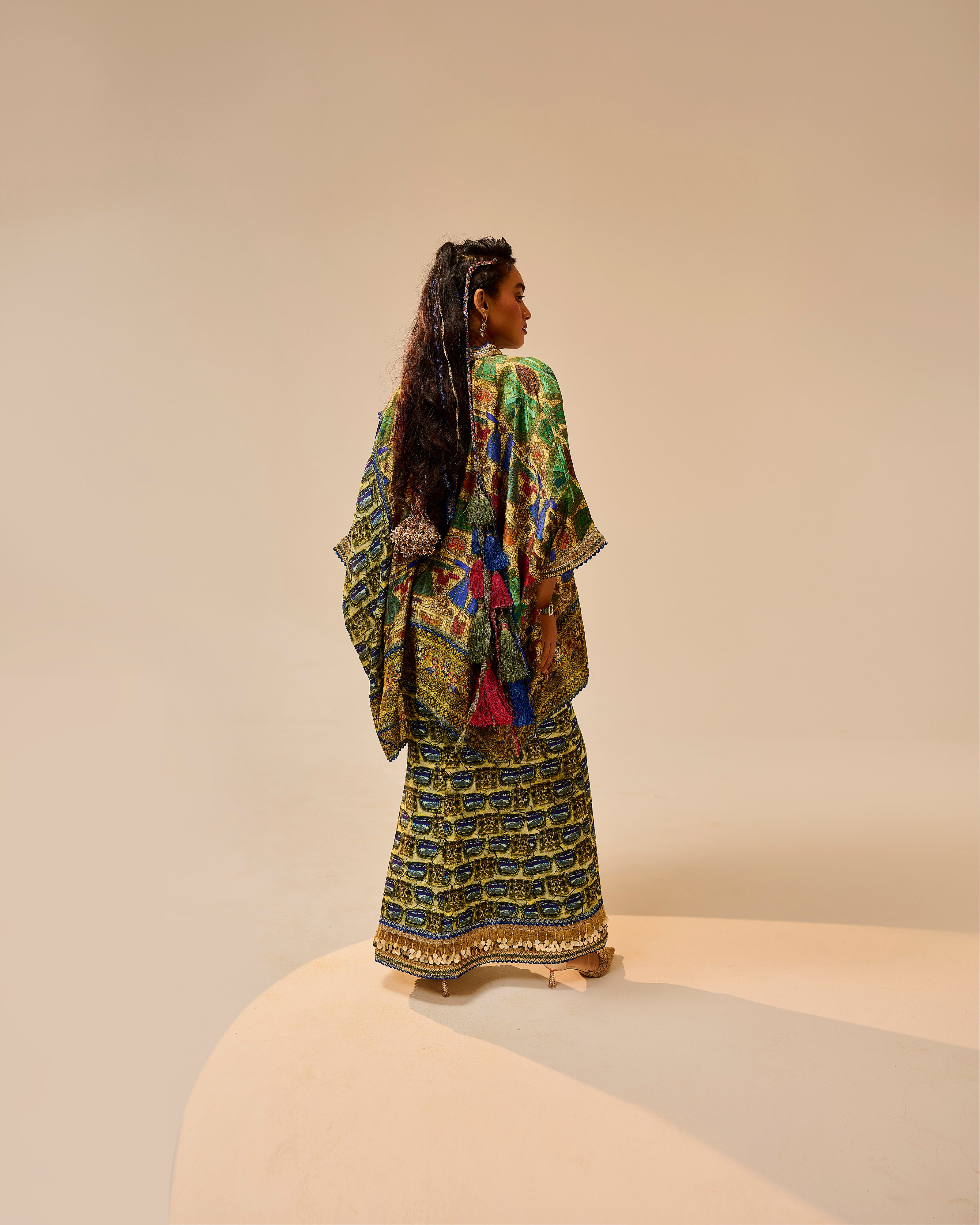 Woman wearing a colorful traditional outfit on a beige background