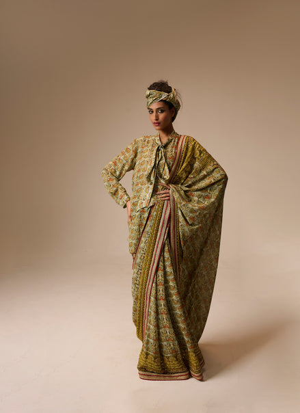 Woman wearing a traditional outfit with a patterned dress and headscarf on a beige background