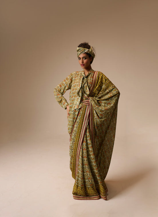 Woman wearing a traditional outfit with a patterned dress and headscarf on a beige background