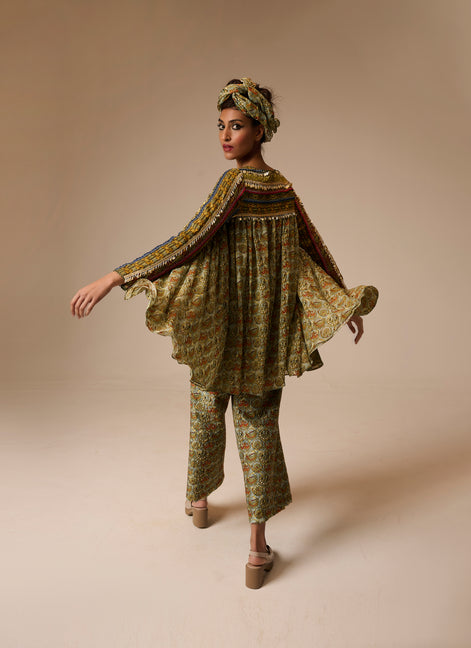 Woman wearing a patterned outfit on a beige background