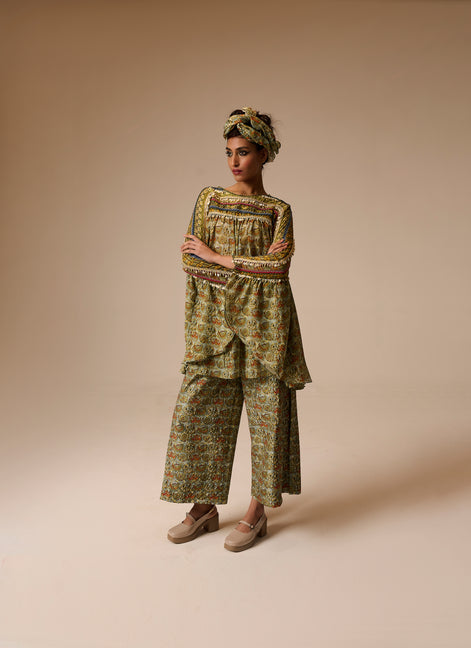Woman wearing a patterned outfit on a beige background