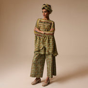 Woman wearing a patterned outfit on a beige background