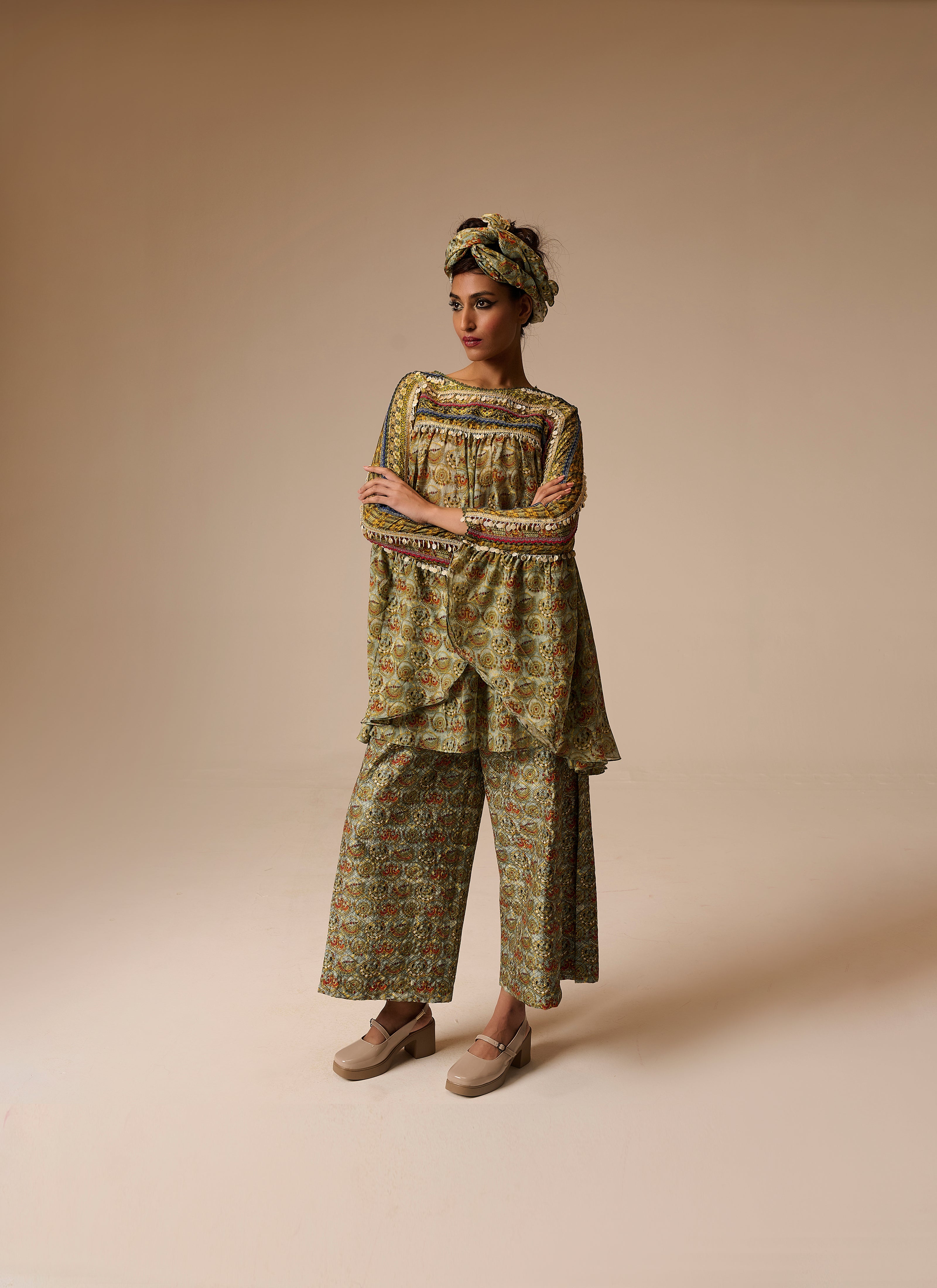Woman wearing a patterned outfit on a beige background