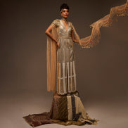 Woman in a long, flowing dress with a brown background