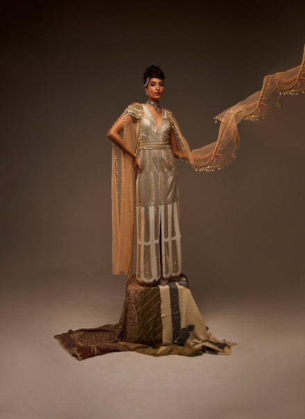 Woman in a long, flowing dress with a brown background