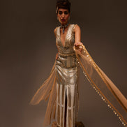 Woman in a vintage-style dress with flowing fabric against a dark background