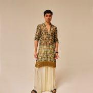 Man wearing a patterned kurta with a plain background