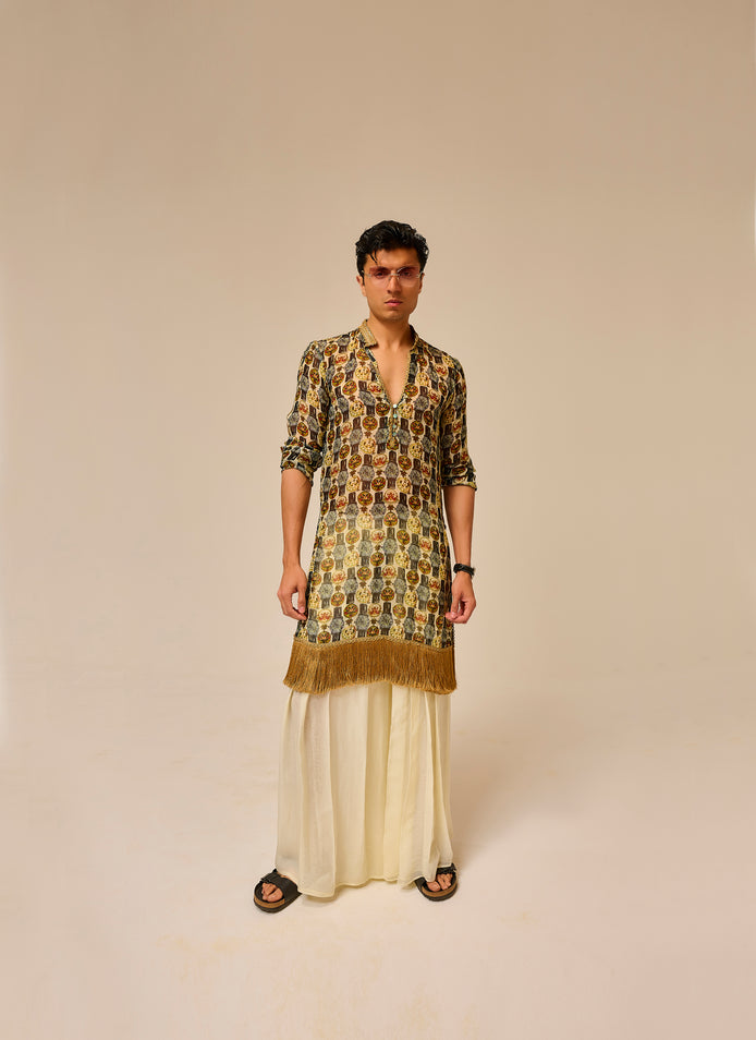Man wearing a patterned kurta with a plain background
