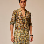 Man wearing a patterned kurta with a plain background