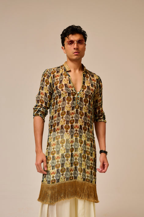Man wearing a patterned kurta with a plain background