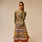 Woman wearing a patterned outfit with a beige background