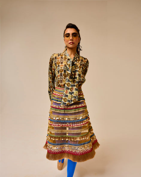Woman wearing a patterned outfit with a beige background