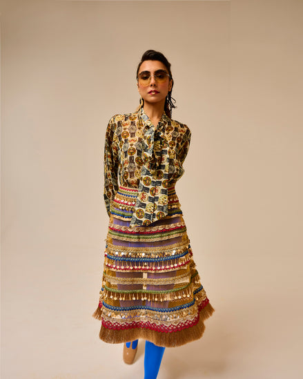 Woman wearing a patterned outfit with a beige background